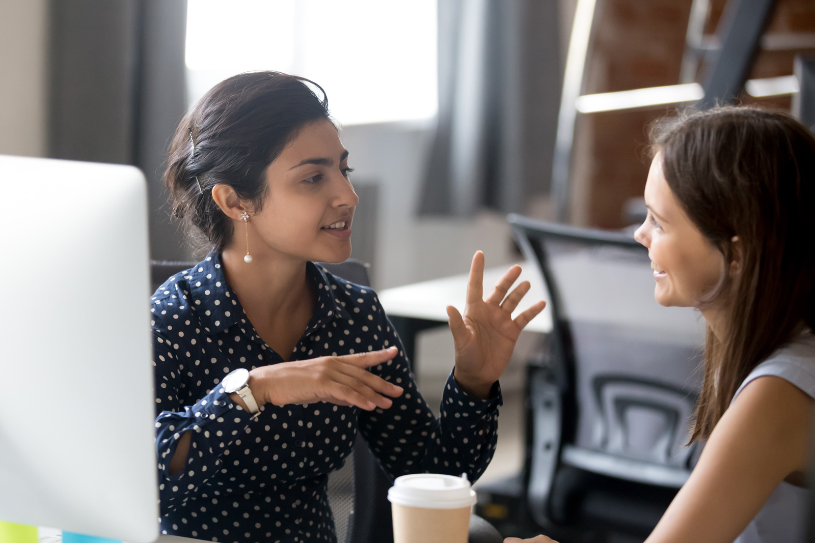 Two women smiling and talking