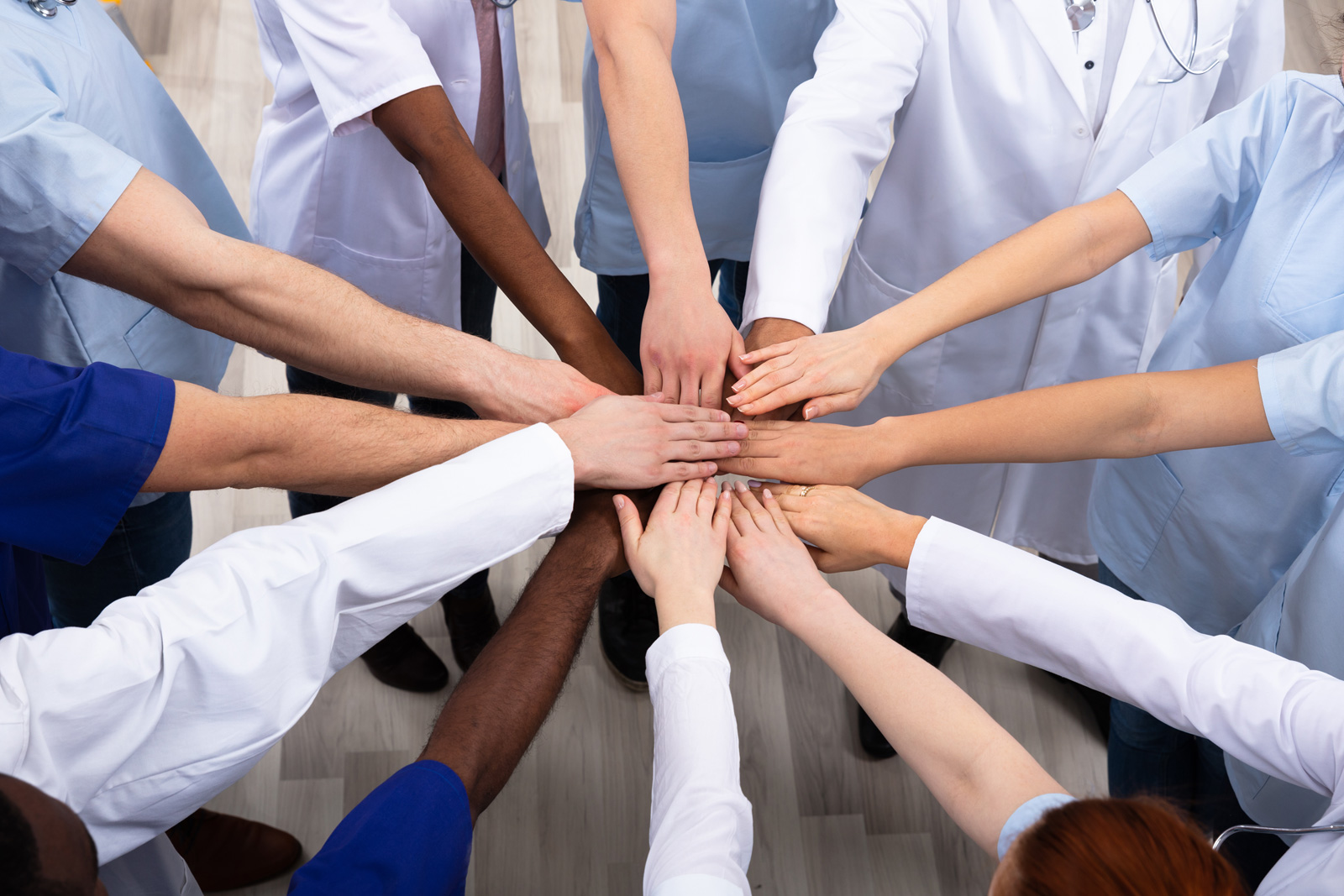 A collection of hands coming together in a circle